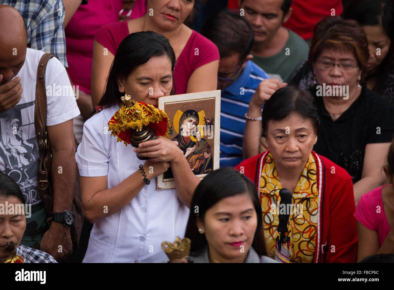 Cebu City, Philippines. 15th January, 2016. ‘Walk with Mary’, a foot penitential procession starting at 4:30 am where thousands of Filipino Catholics flock to the oldest Roman Catholic Church in the Philippines - the Basilica Minore del St.Nino in Cebu City. The religious event is part of Sinulog (Fiesta Señor) - a nine day religious festival honouring the Santo Nino De Cebu (Holy Child of Cebu). Many devotees bring with them a Santo Nino figurine representing the Child Jesus. Credit:  imagegallery2/Alamy Live News Stock Photo