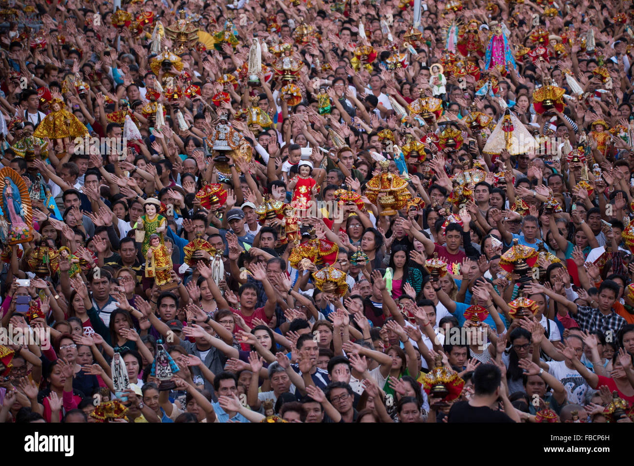 Cebu City, Philippines. 15th January, 2016. ‘Walk with Mary’, a foot penitential procession starting at 4:30 am where thousands of Filipino Catholics flock to the oldest Roman Catholic Church in the Philippines - the Basilica Minore del St.Nino in Cebu City. The religious event is part of Sinulog (Fiesta Señor) - a nine day religious festival honouring the Santo Nino De Cebu (Holy Child of Cebu). Many devotees bring with them a Santo Nino figurine representing the Child Jesus. Credit:  imagegallery2/Alamy Live News Stock Photo