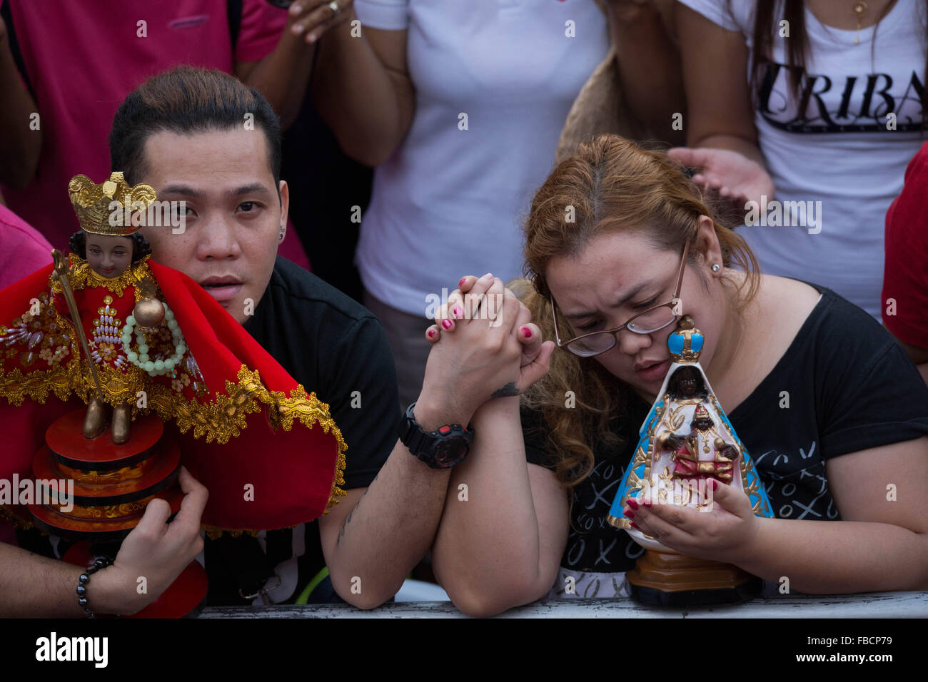 Cebu City, Philippines. 15th January, 2016. ‘Walk with Mary’, a foot penitential procession starting at 4:30 am where thousands of Filipino Catholics flock to the oldest Roman Catholic Church in the Philippines - the Basilica Minore del St.Nino in Cebu City. The religious event is part of Sinulog (Fiesta Señor) - a nine day religious festival honouring the Santo Nino De Cebu (Holy Child of Cebu). Many devotees bring with them a Santo Nino figurine representing the Child Jesus. Credit:  imagegallery2/Alamy Live News Stock Photo