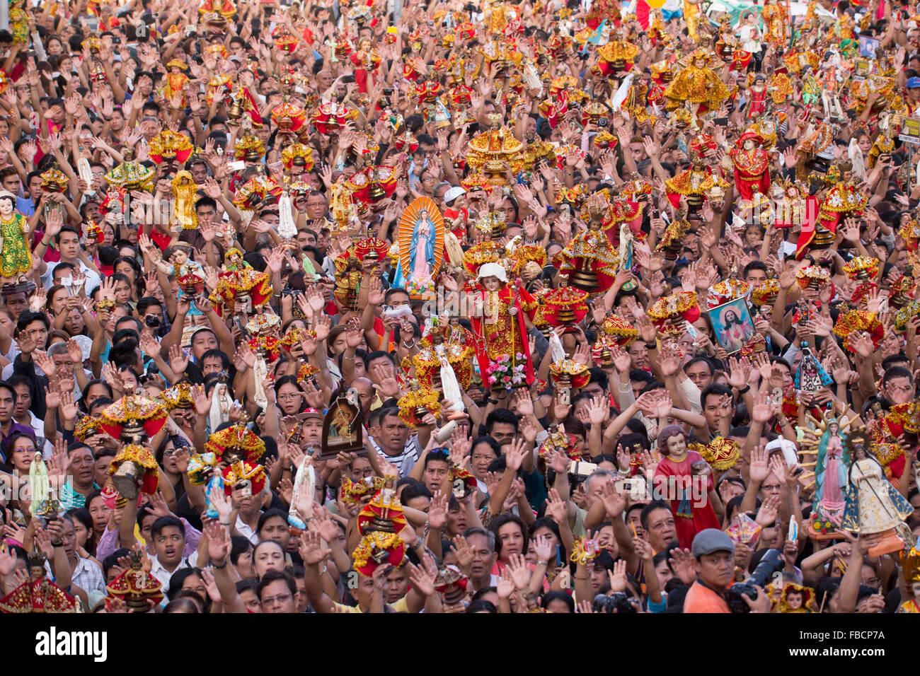 Cebu City, Philippines. 15th January, 2016. ‘Walk with Mary’, a foot penitential procession starting at 4:30 am where thousands of Filipino Catholics flock to the oldest Roman Catholic Church in the Philippines - the Basilica Minore del St.Nino in Cebu City. The religious event is part of Sinulog (Fiesta Señor) - a nine day religious festival honouring the Santo Nino De Cebu (Holy Child of Cebu). Many devotees bring with them a Santo Nino figurine representing the Child Jesus. Credit:  imagegallery2/Alamy Live News Stock Photo