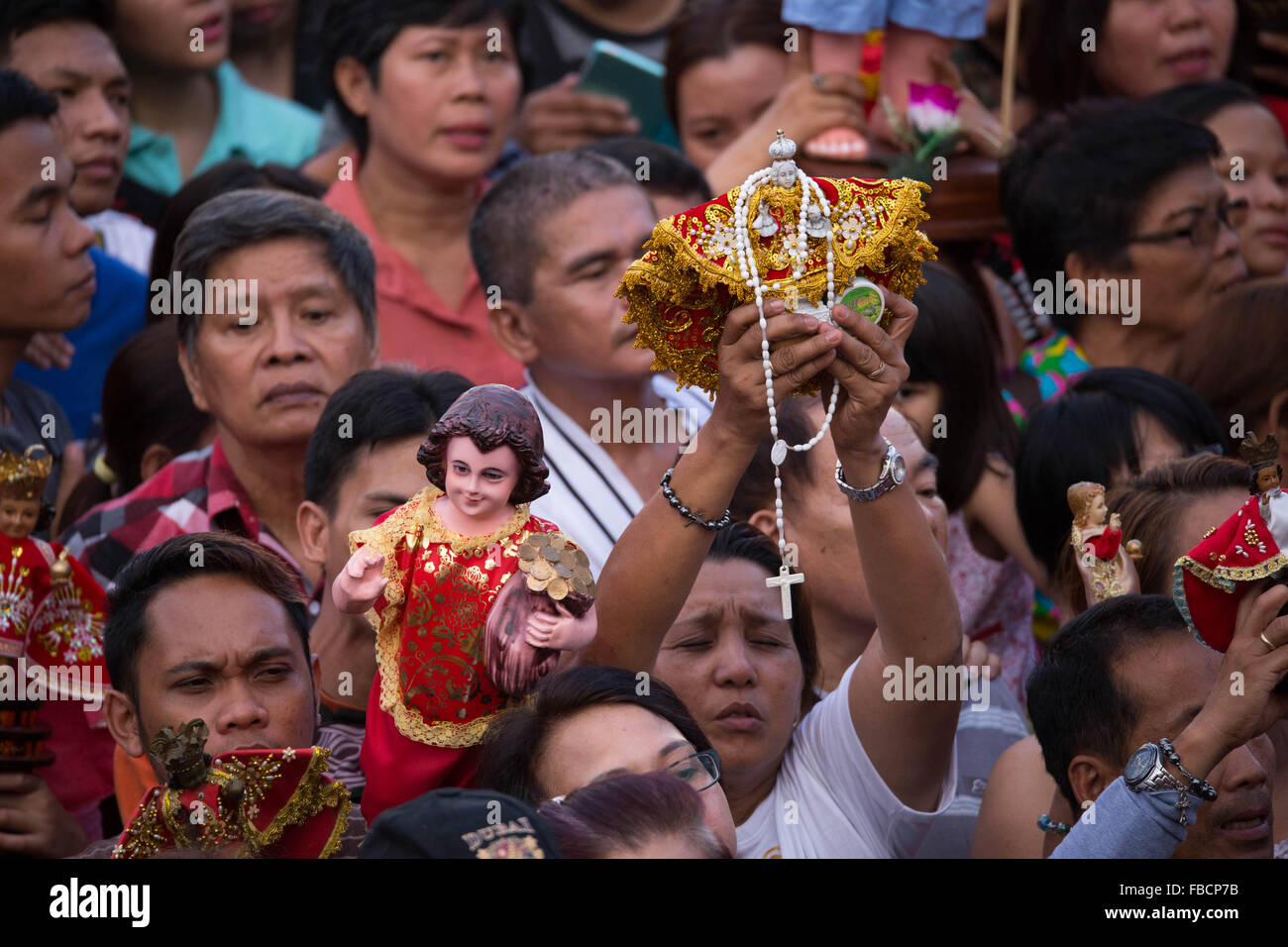 Cebu City, Philippines. 15th January, 2016. ‘Walk with Mary’, a foot penitential procession starting at 4:30 am where thousands of Filipino Catholics flock to the oldest Roman Catholic Church in the Philippines - the Basilica Minore del St.Nino in Cebu City. The religious event is part of Sinulog (Fiesta Señor) - a nine day religious festival honouring the Santo Nino De Cebu (Holy Child of Cebu). Many devotees bring with them a Santo Nino figurine representing the Child Jesus. Credit:  imagegallery2/Alamy Live News Stock Photo