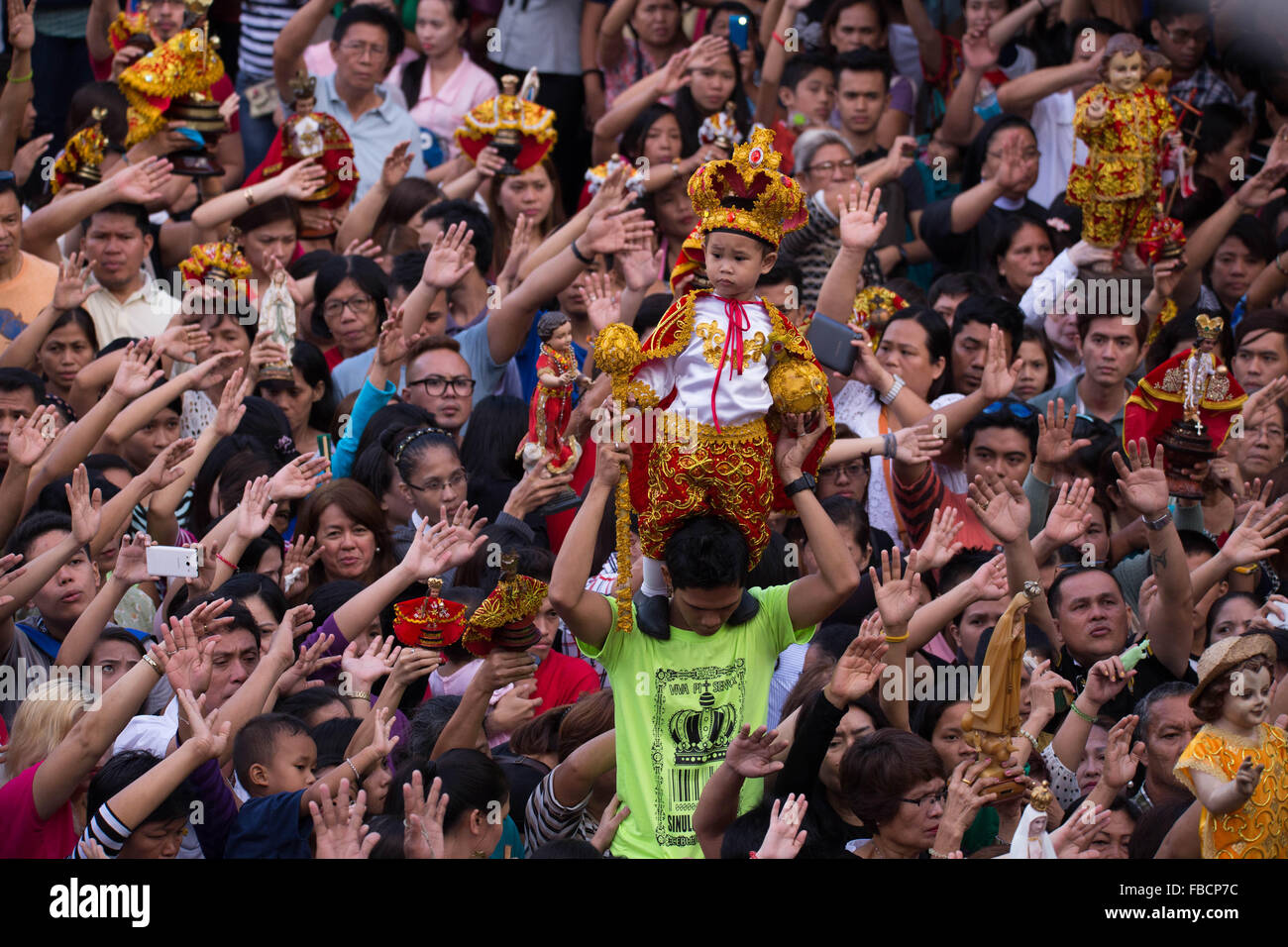 Cebu City, Philippines. 15th January, 2016. ‘Walk with Mary’, a foot penitential procession starting at 4:30 am where thousands of Filipino Catholics flock to the oldest Roman Catholic Church in the Philippines - the Basilica Minore del St.Nino in Cebu City. The religious event is part of Sinulog (Fiesta Señor) - a nine day religious festival honouring the Santo Nino De Cebu (Holy Child of Cebu). Many devotees bring with them a Santo Nino figurine representing the Child Jesus. Credit:  imagegallery2/Alamy Live News Stock Photo
