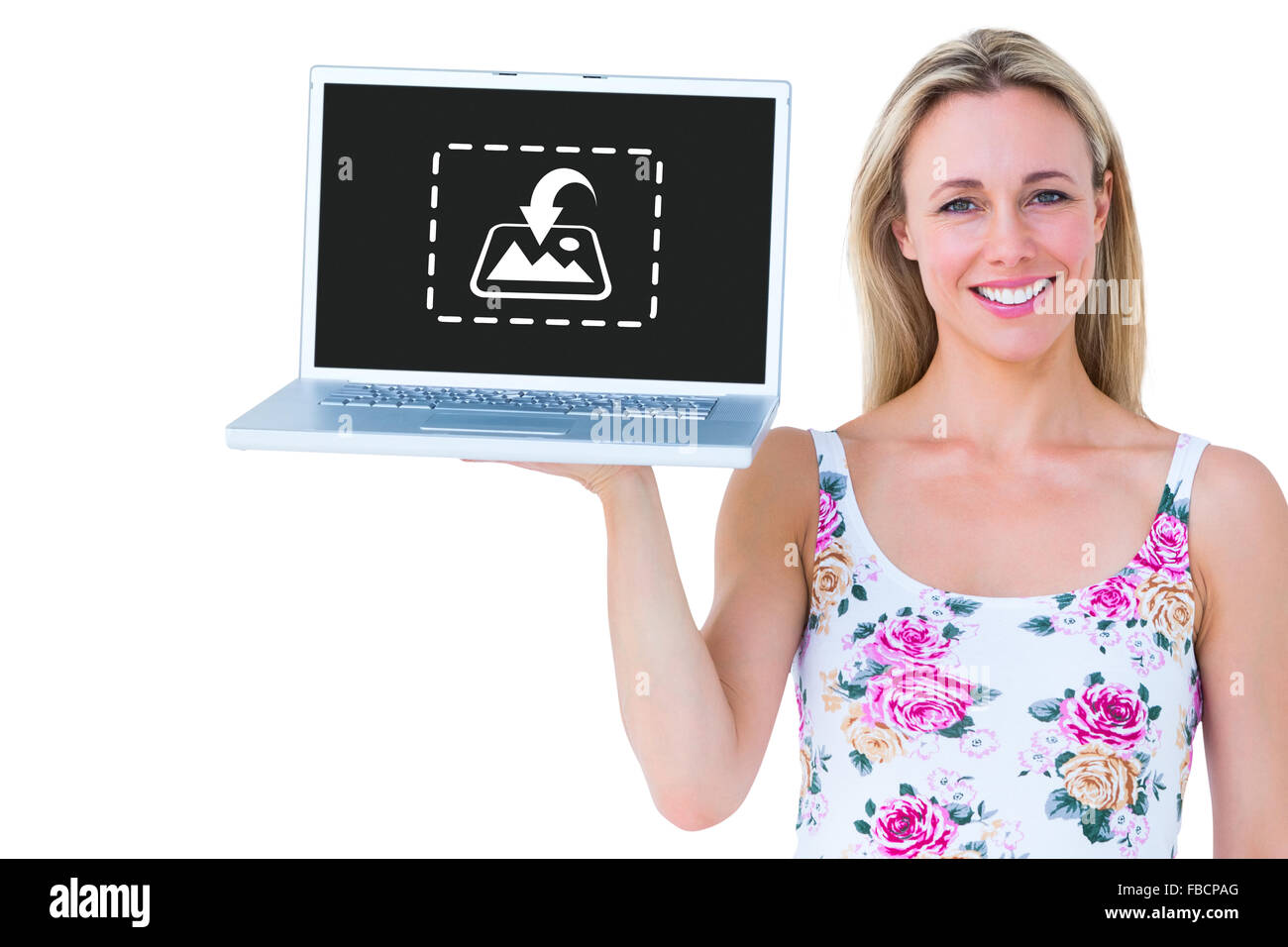 Composite image of smiling blonde holding laptop and posing Stock Photo