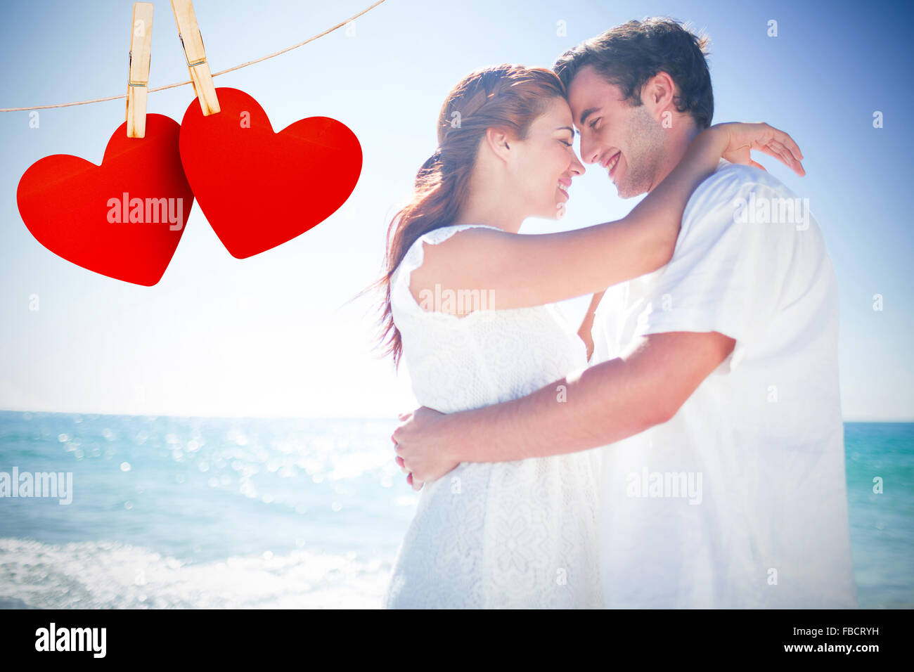 Composite image of happy couple hugging and smiling at each other Stock Photo