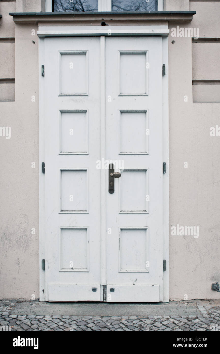 A closed white double door in an urban building in Berlin, Germany Stock Photo
