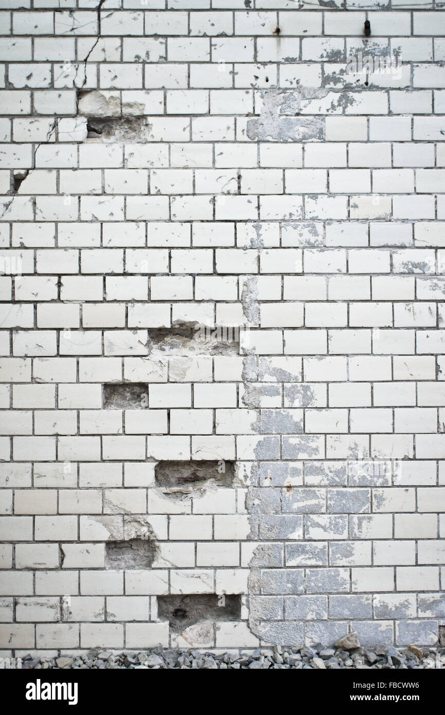 Part of a damaged white brick wall Stock Photo