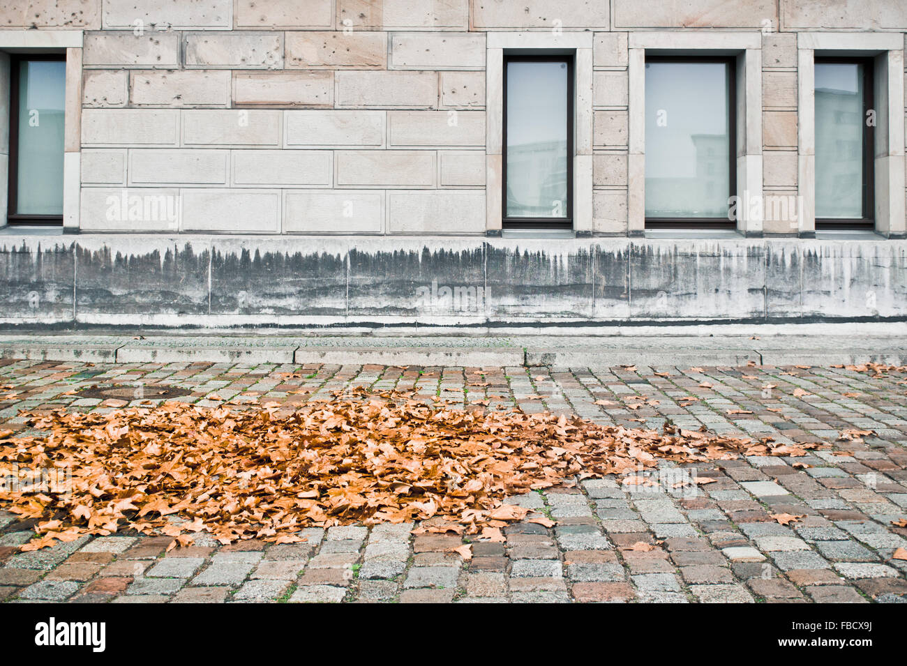 Brick wall background autumn leaves hi-res stock photography and