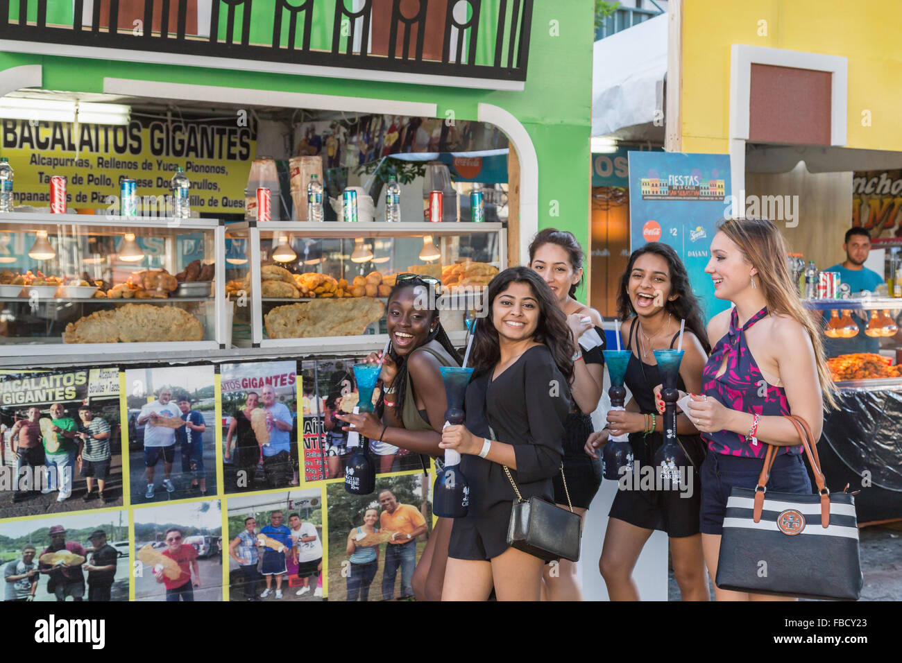 San Juan, Puerto Rico. 14th January, 2016. A group of young women pose in front of the food stall at the San Sebastian Festival. Stock Photo