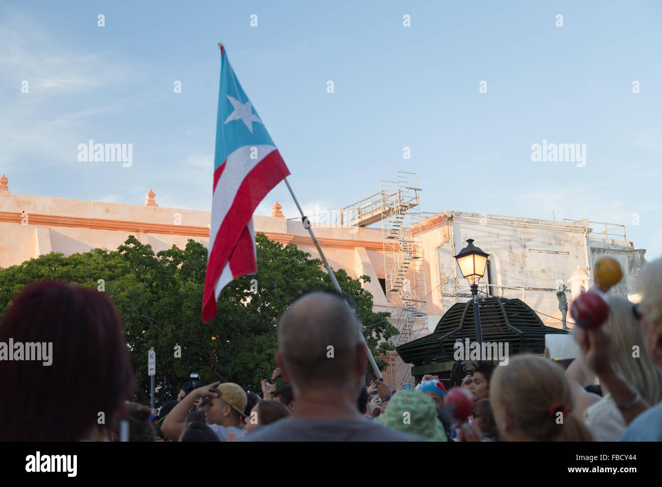 San Juan, Puerto Rico. 14th January, 2016. A person carries a Puerto Rican flag at the San Sebastian Street Festival. Maria S./Alamy Live News Stock Photo