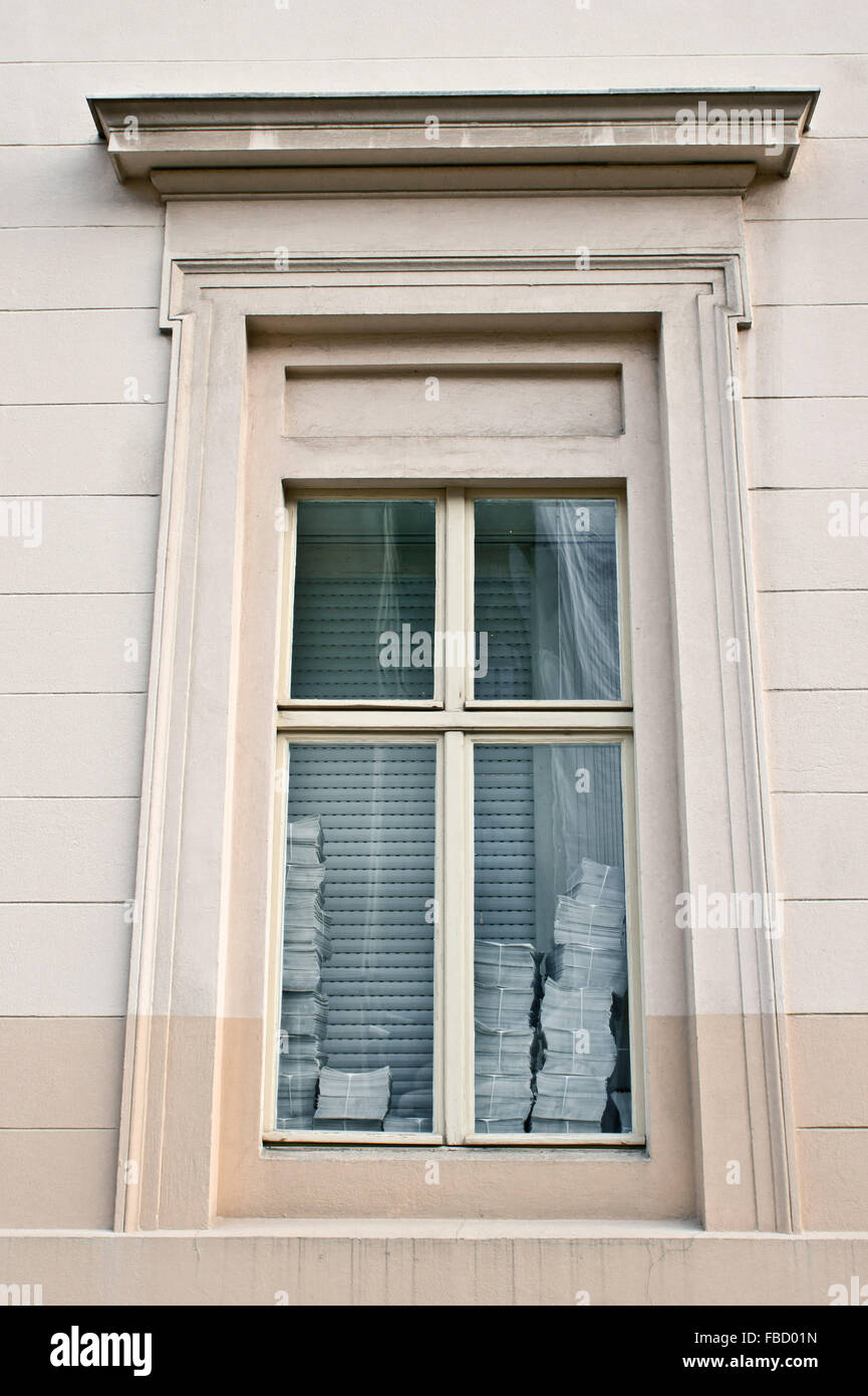 Piles of papers in the window of an office Stock Photo