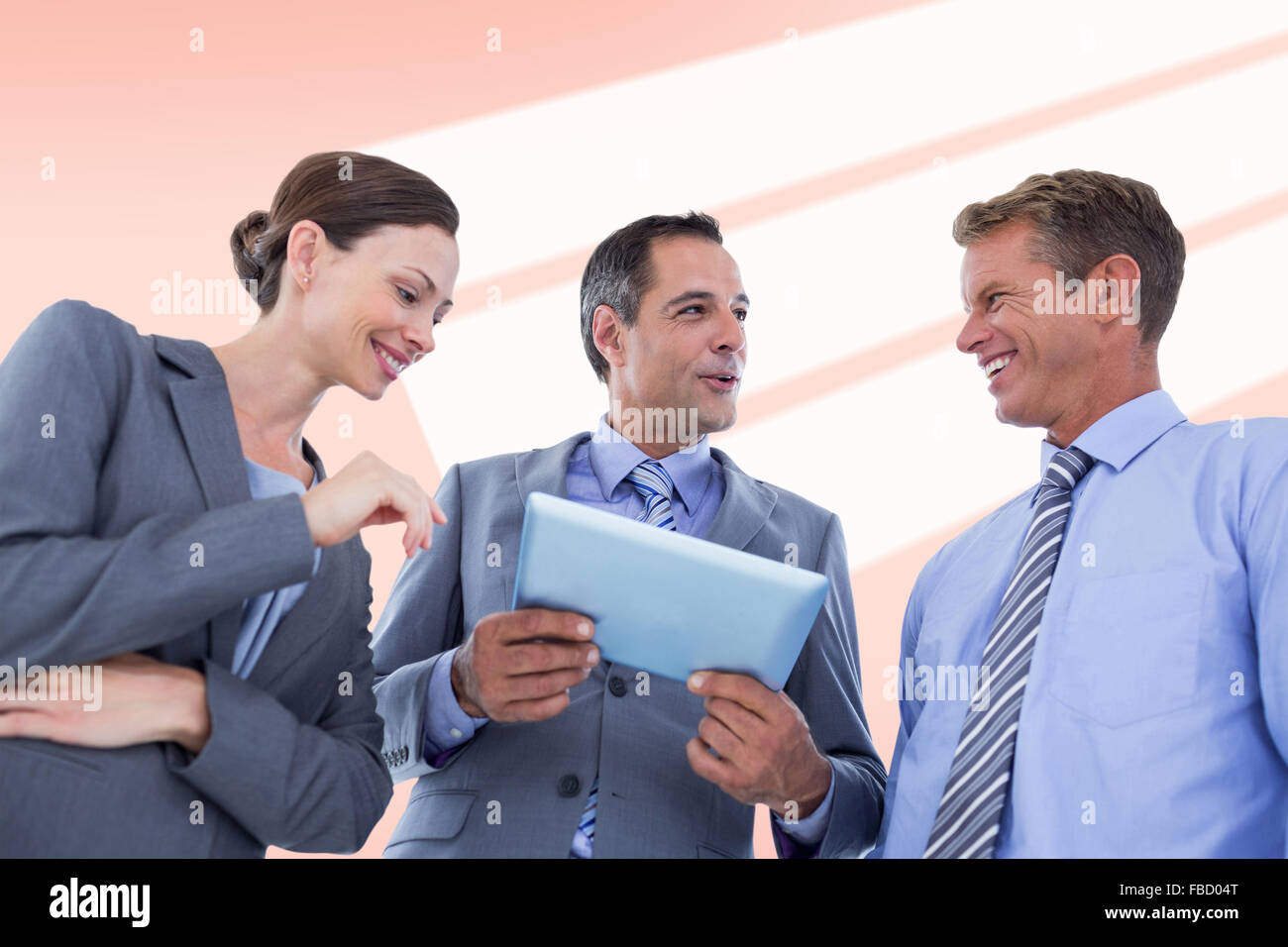 Composite image of businessman showing tablet to his colleagues Stock Photo