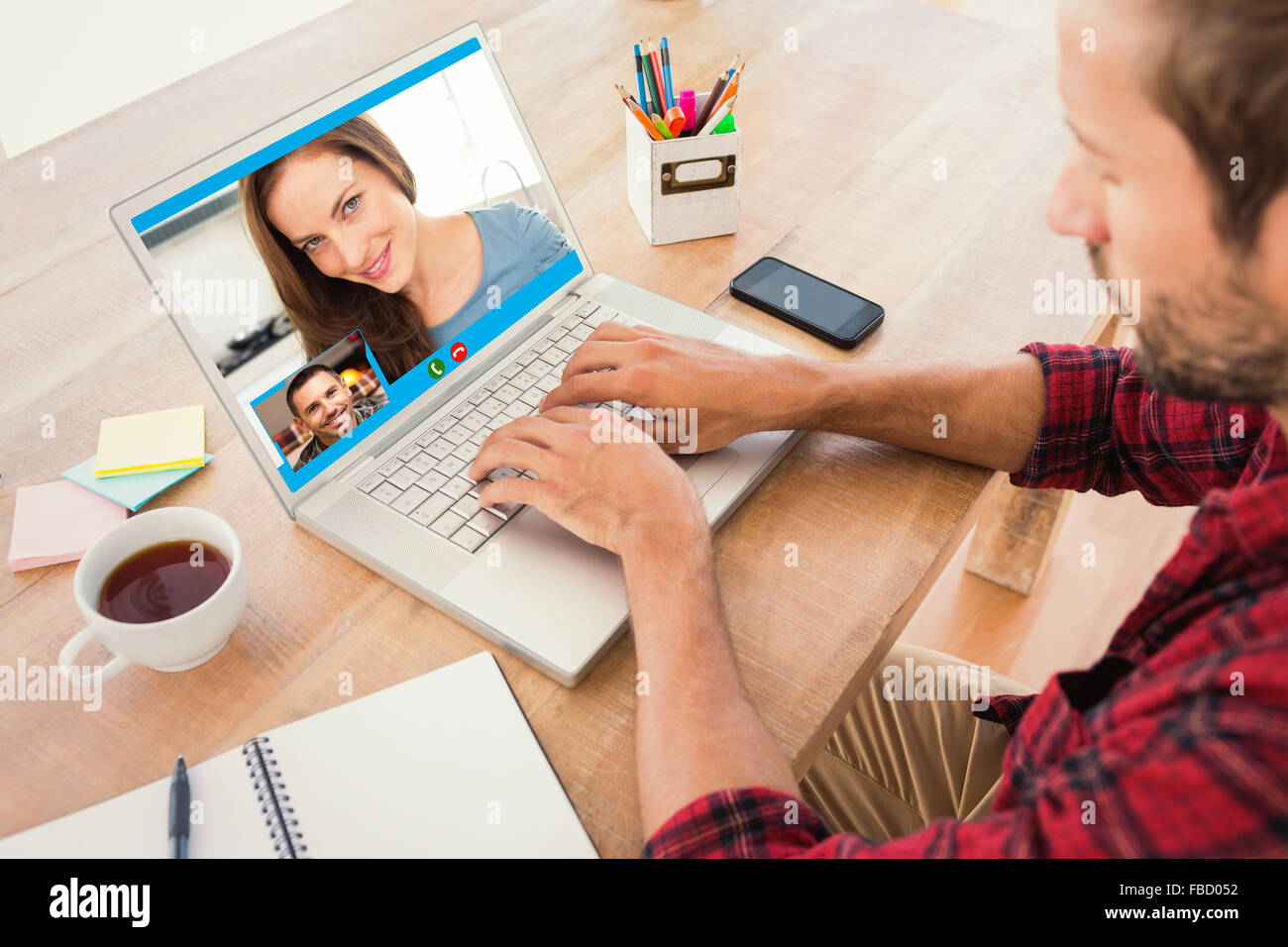 Composite image of creative businessman typing on laptop Stock Photo