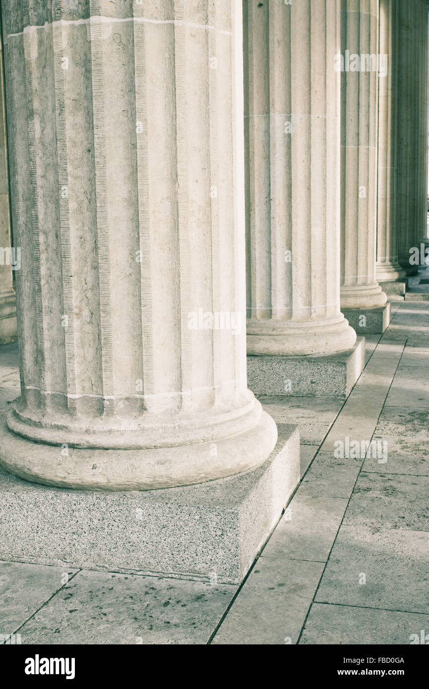 Large stone pillars at the base of a historic building Stock Photo
