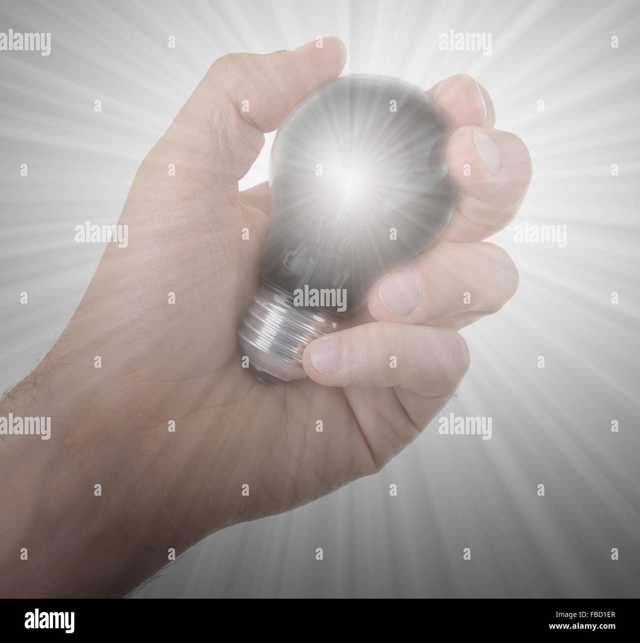 Hand holding an light bulb isolated on white background Stock Photo - Alamy