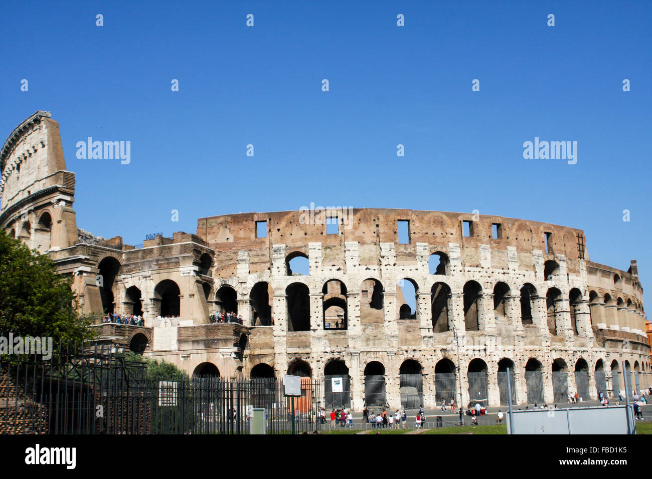 ROME, ITALY- JUNE 2, 2012: Unidentified people by Colloseum in Rome, Italy. It is most remarkable landmark of Rome and Italy. Th Stock Photo