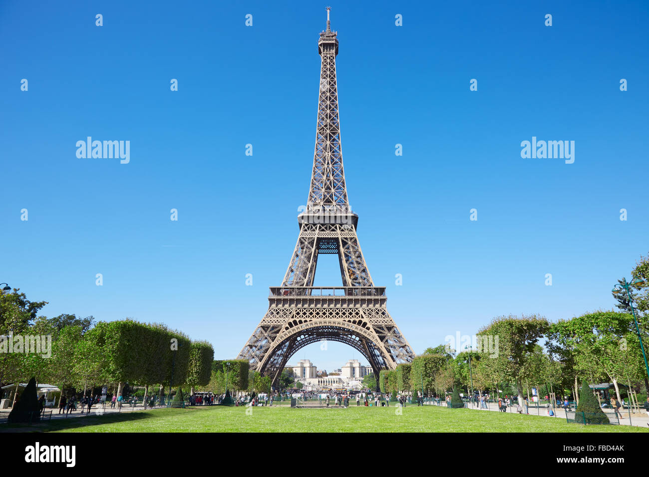 Eiffel tower, sunny summer day with blue sky and green Field of Mars in Paris Stock Photo