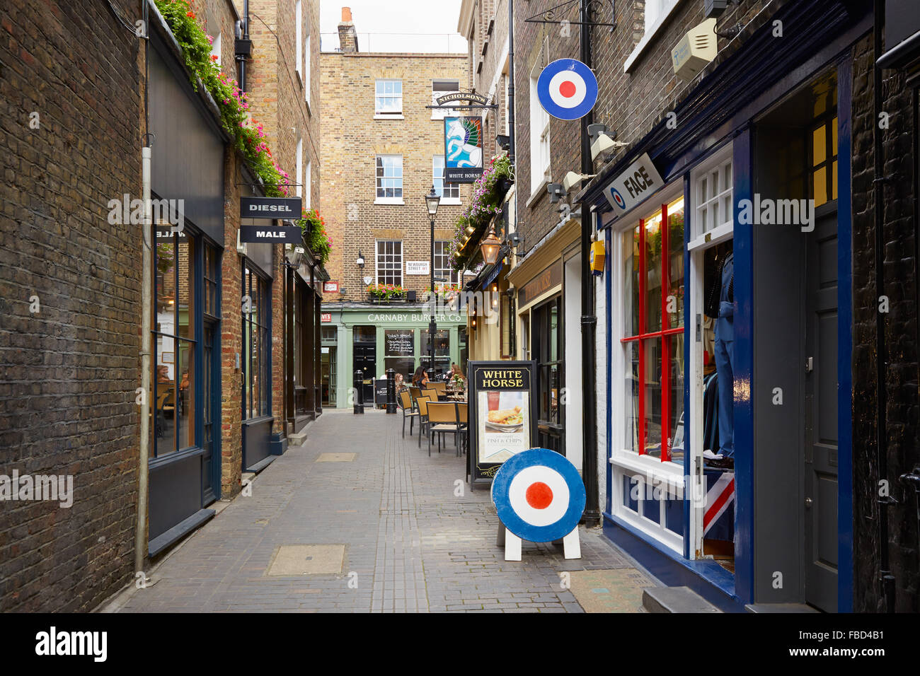 Typical Newburgh street with brick houses and pub near Carnaby street in London Stock Photo