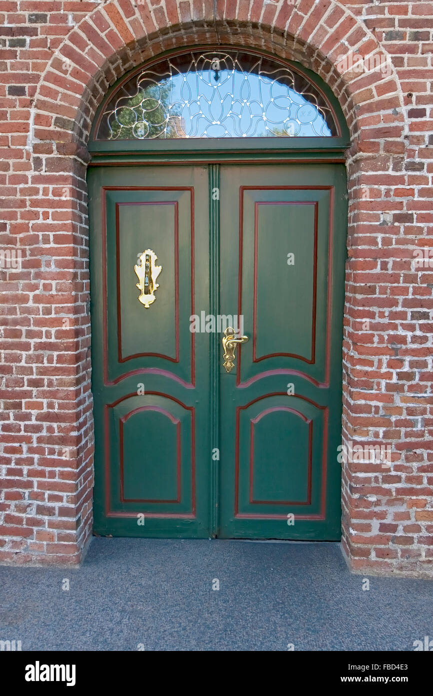 Closeup on green double door with brass door knocker Stock Photo Alamy