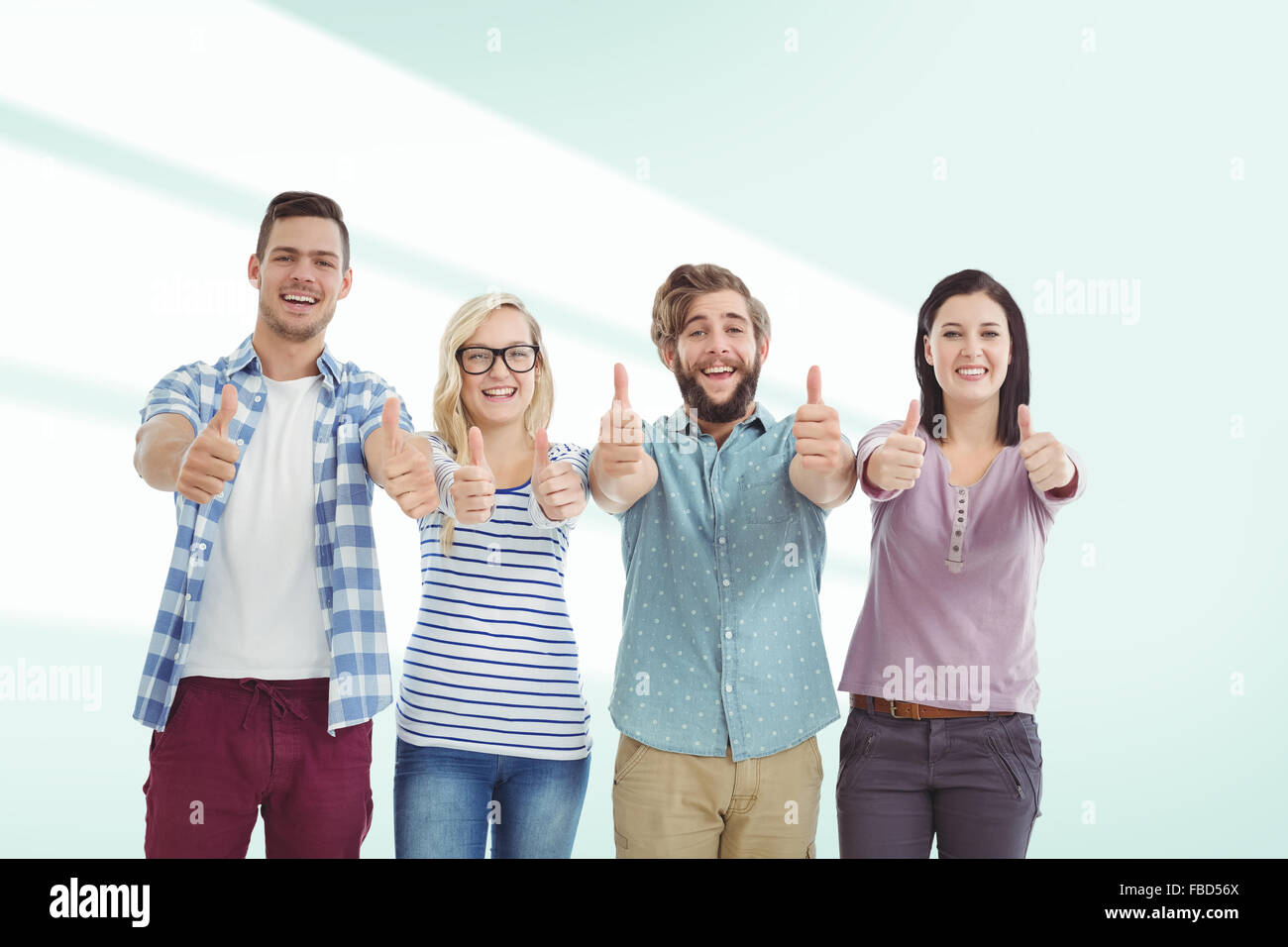 Composite image of portrait of smiling business people with thumbs up Stock Photo