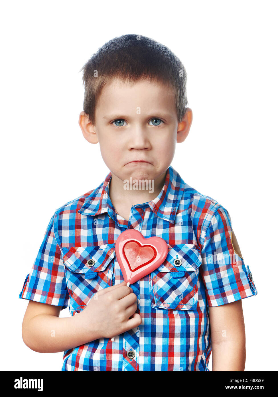 Funny dissatisfied boy with lollipop hearts isolated Stock Photo