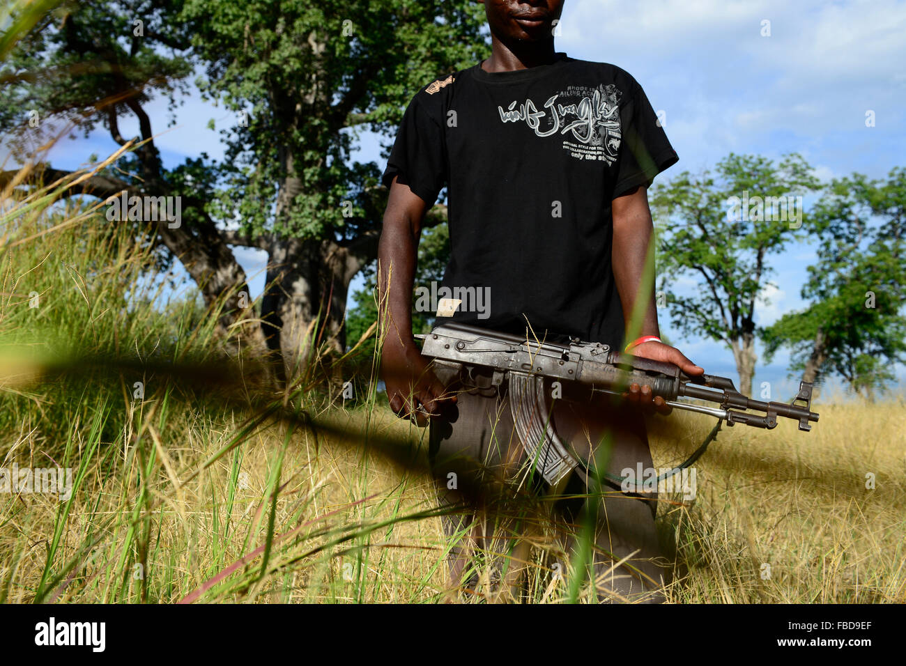 Zambia Chiawa, Game Reserve Area of Lower Zambezi Nationalpark, Ranger and Scout with Kalashnikov AK-47 who is employed by the private wildlife lodge of Charles Daves Stock Photo