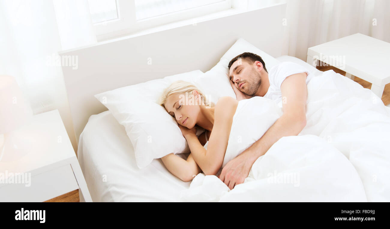 Happy couple in love sleeping together at home Stock Photo - Alamy