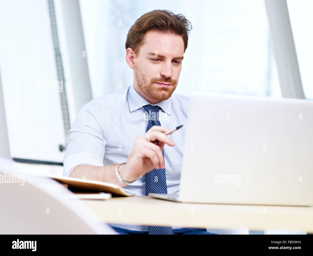 business man working in office with laptop Stock Photo