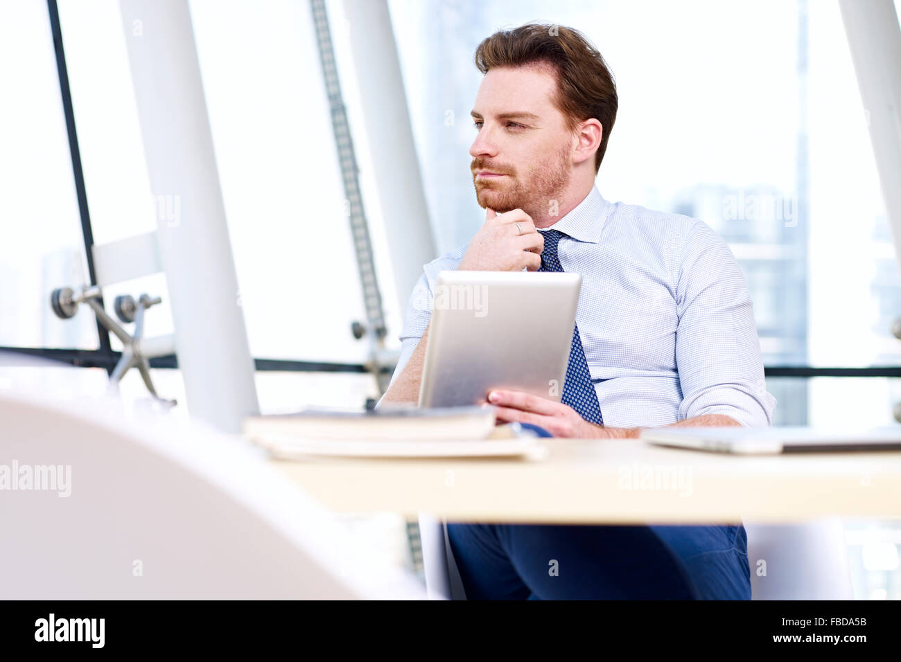 business executive sitting in office thinking Stock Photo