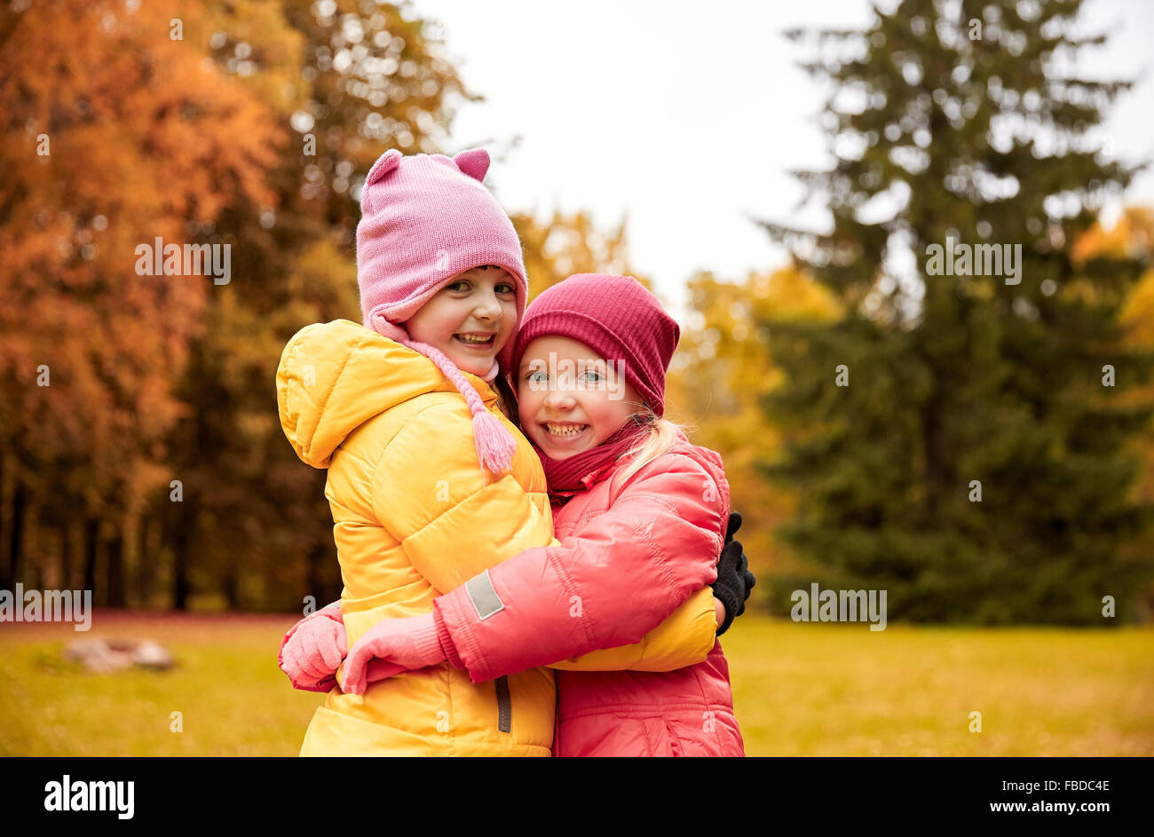 two happy little girls hugging in autumn park Stock Photo - Alamy