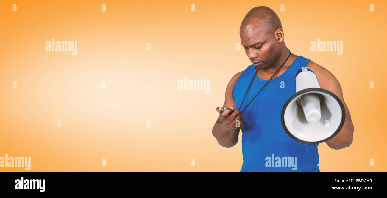 Composite image of fit trainer checking his stopwatch Stock Photo
