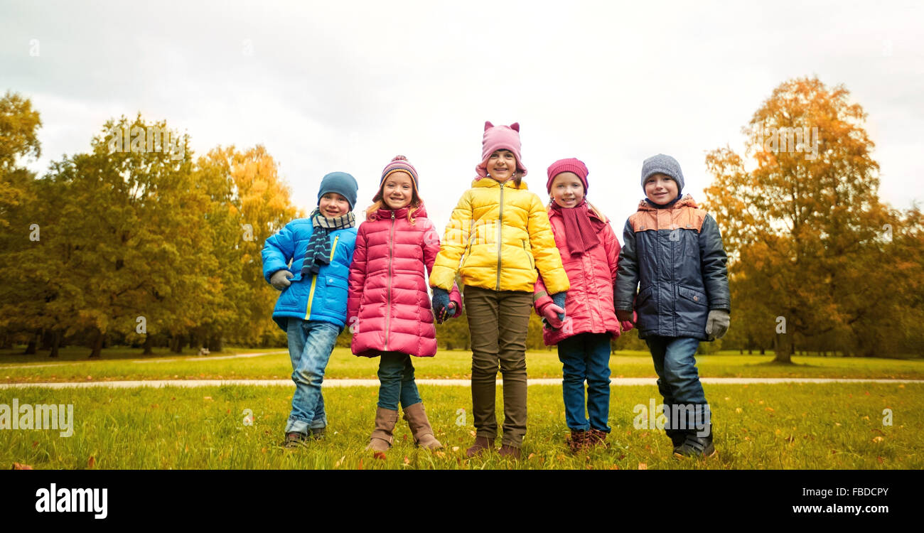 happy children holding hands in autumn park Stock Photo - Alamy