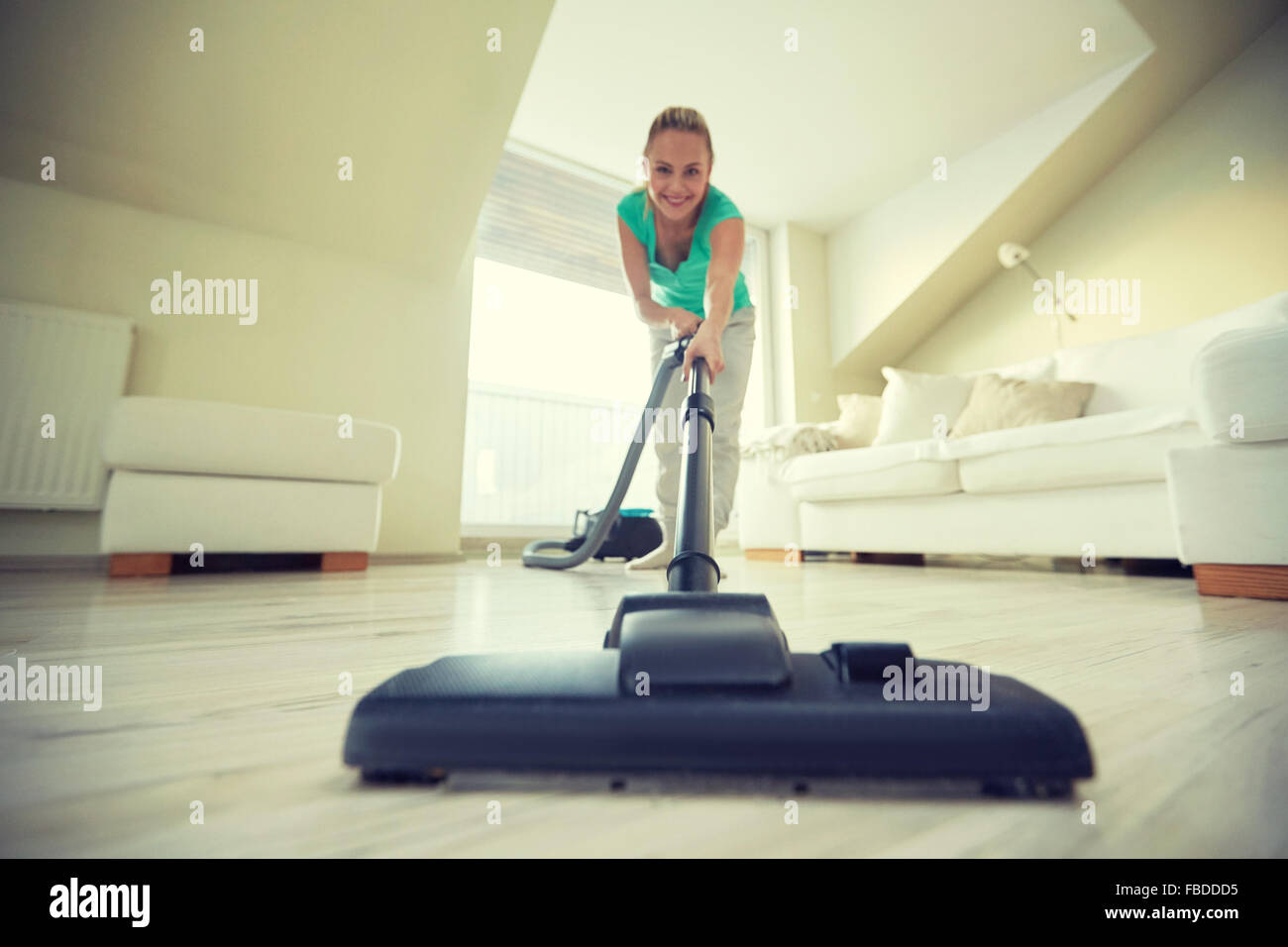 happy woman with vacuum cleaner at home Stock Photo