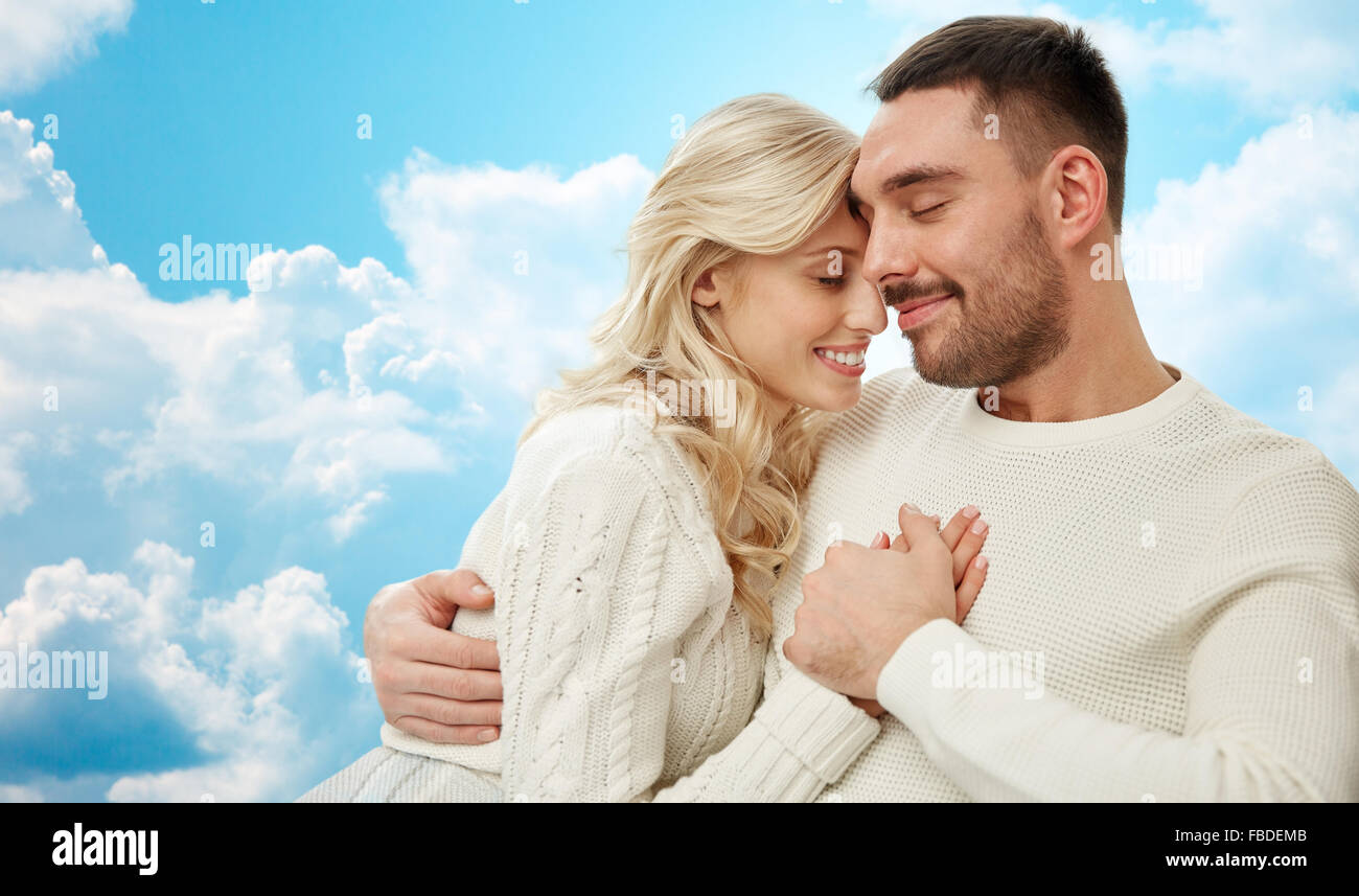happy couple cuddling over blue sky and clouds Stock Photo - Alamy