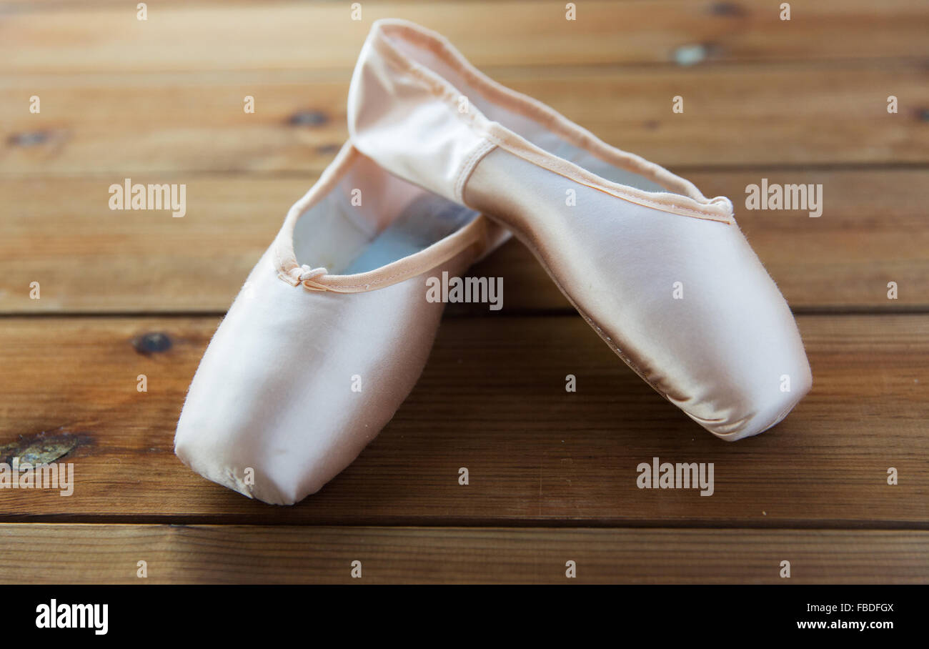 close up of pointe shoes on wooden floor Stock Photo
