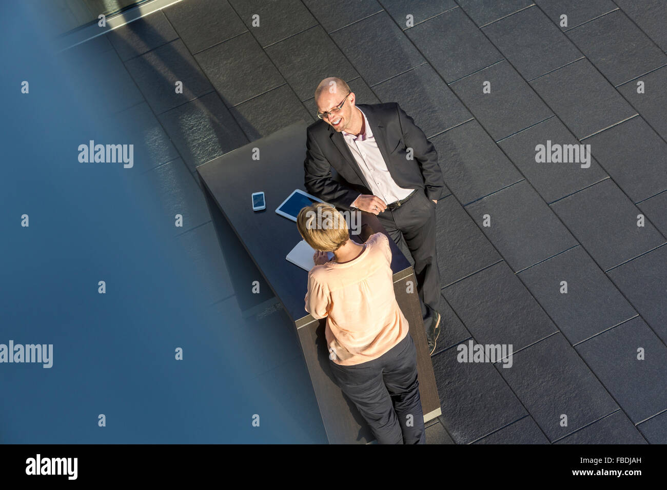 Business women and man discussing on bar table, elevated view Stock Photo