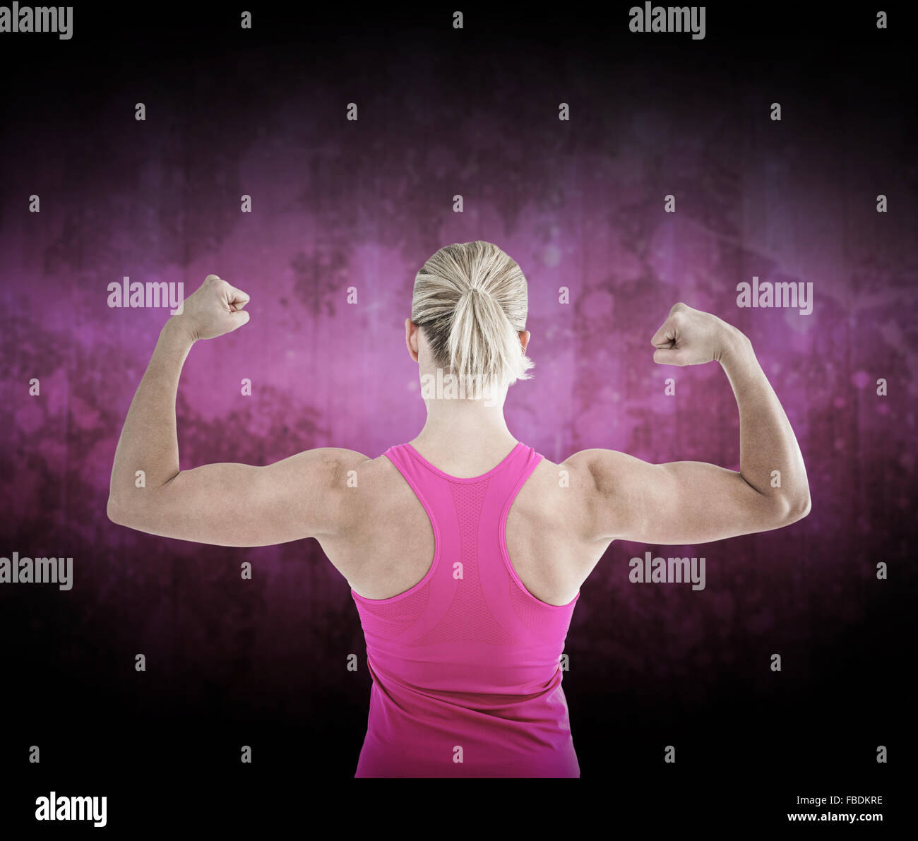 Composite image of rear view of muscular woman flexing muscles Stock Photo