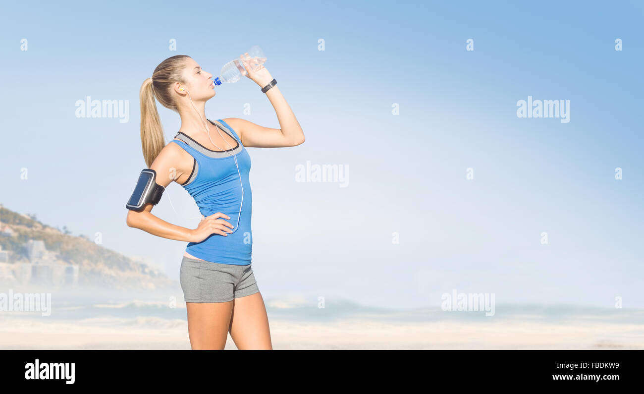 Composite image of fit woman with water Stock Photo