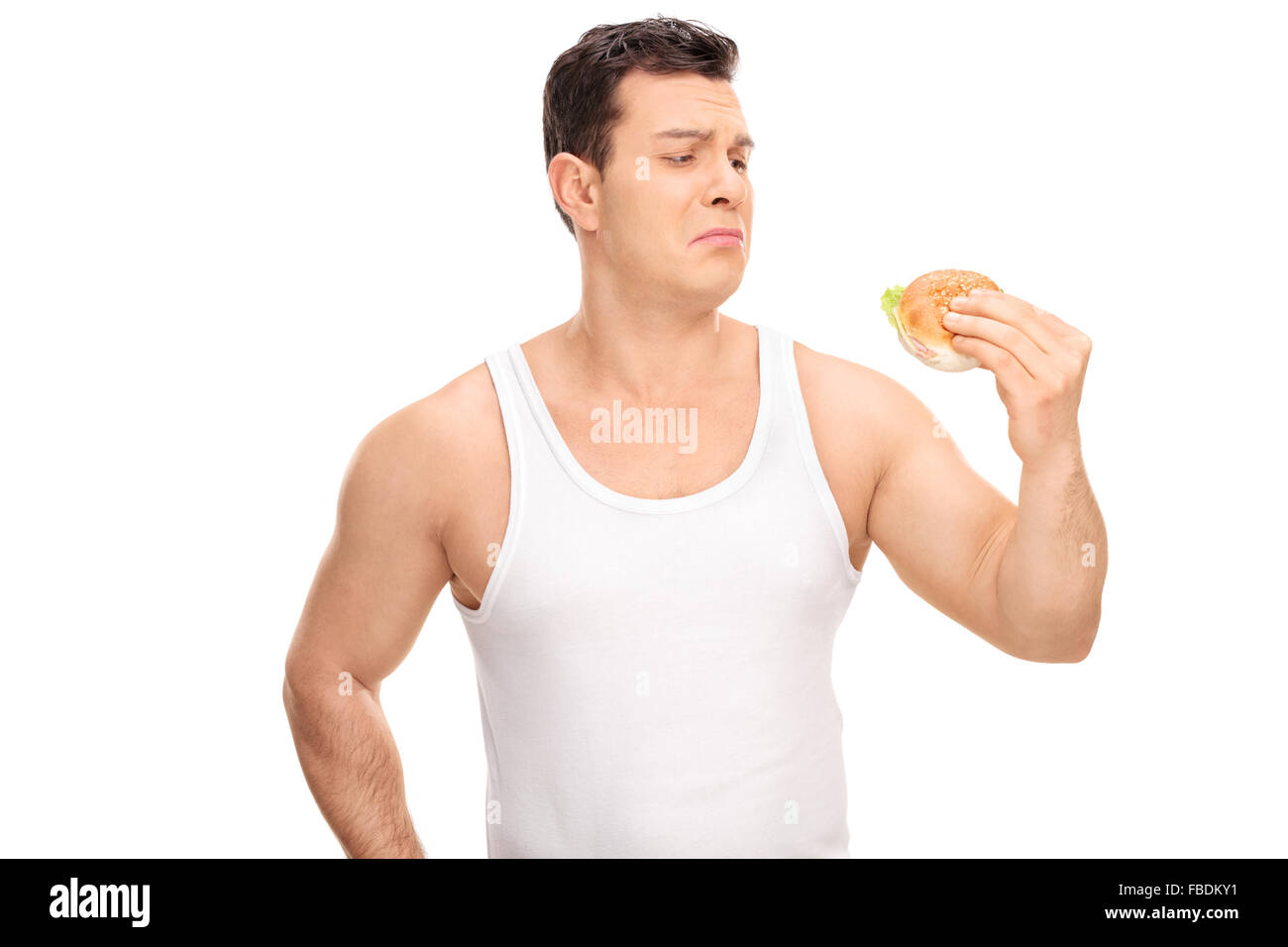 Studio shot of a sad young guy holding a small sandwich isolated on white  background Stock Photo - Alamy