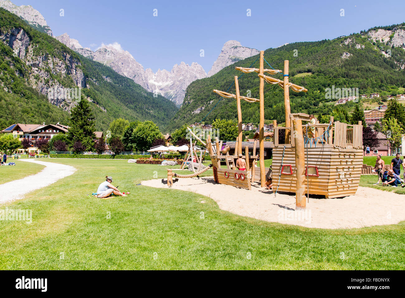 Molveno, Italy - July 10: Playground structures with natural wood on the banks of Lake Molveno surrounded by the Alps in Molveno Stock Photo