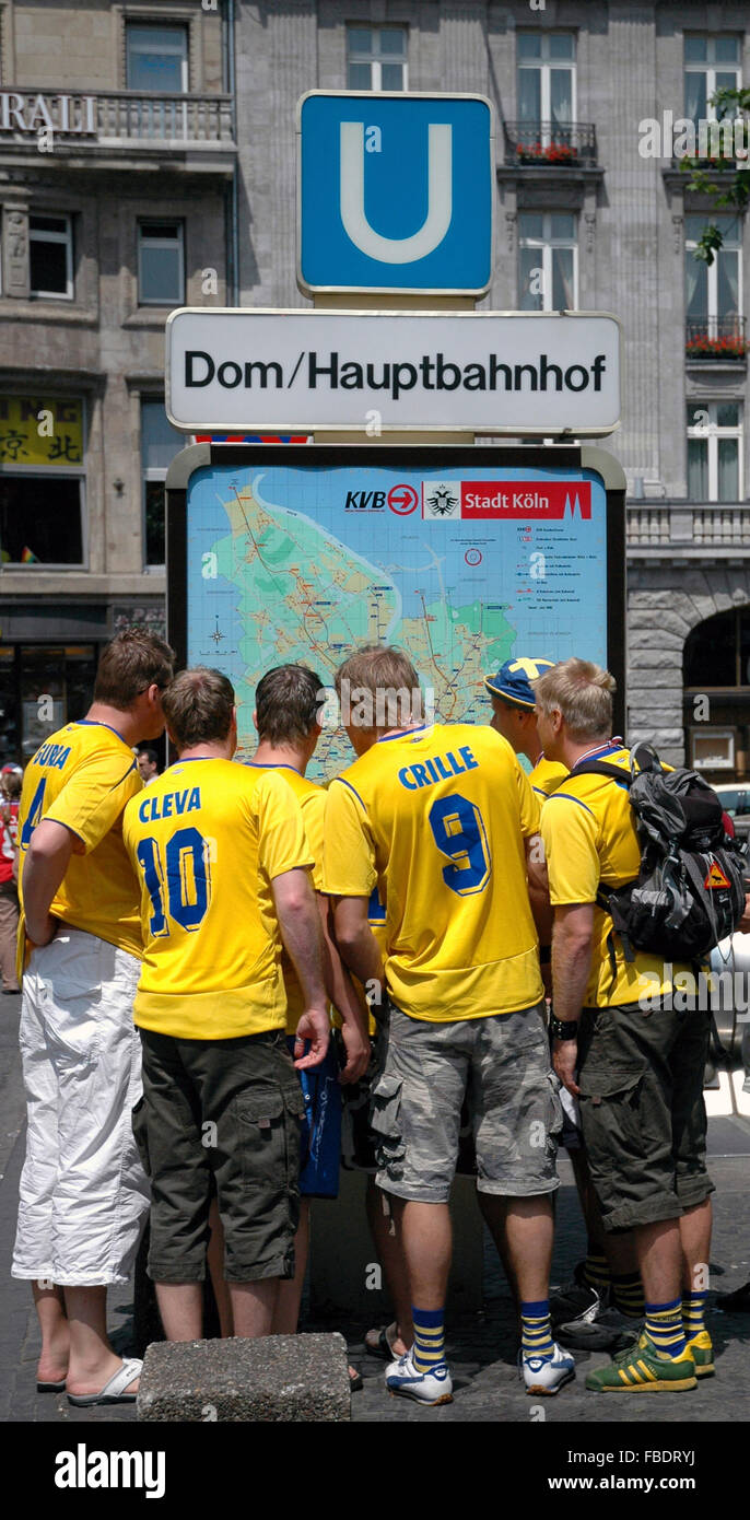 Swedish football fans looking at map Stock Photo