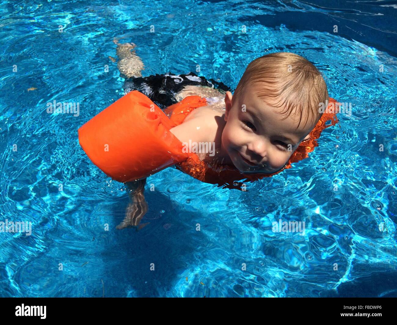 High Angle Portrait Of Smiling Boy Swimming In Pool Stock Photo - Alamy