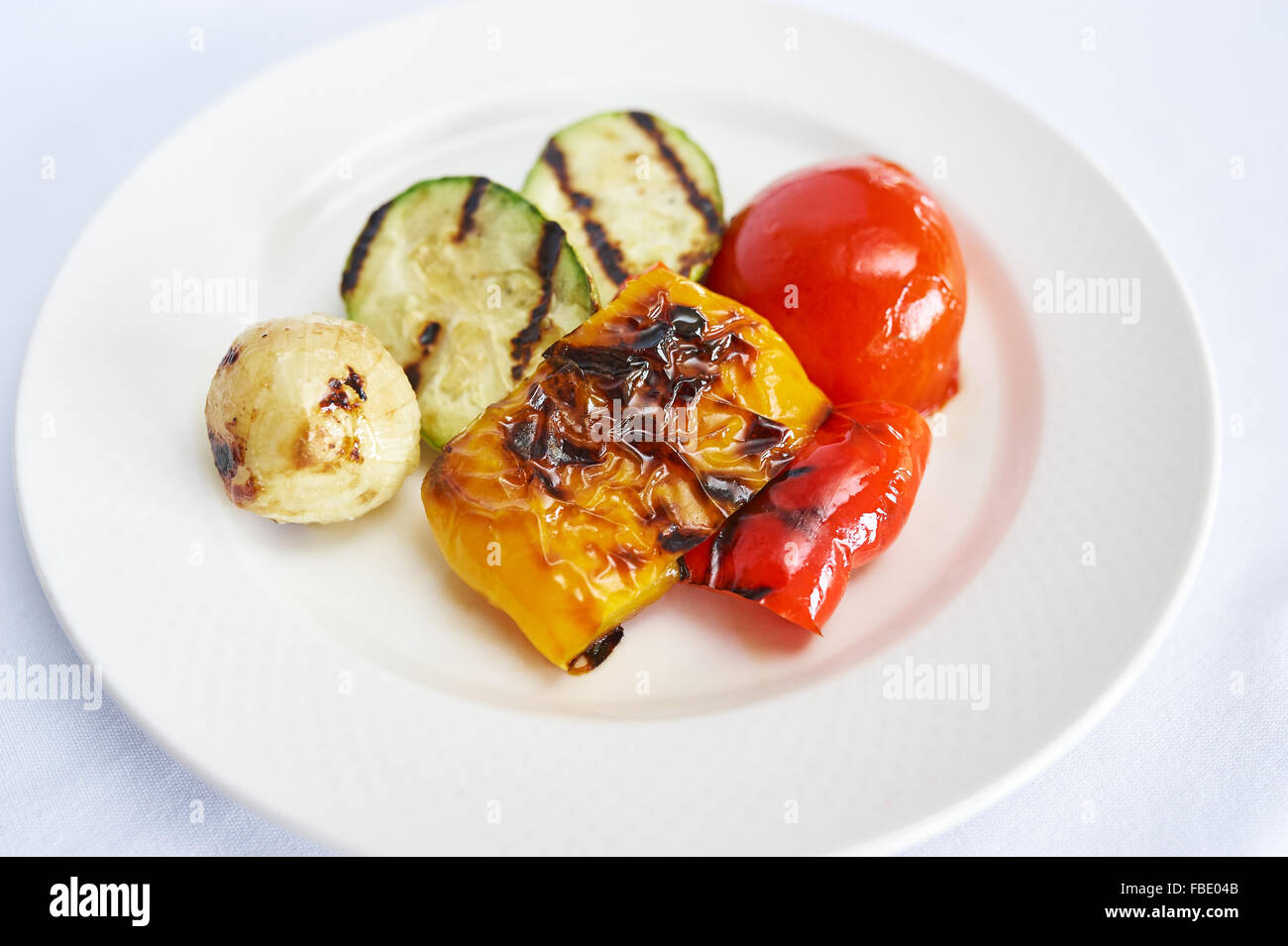 Grilled vegetables on white plate studio shot Stock Photo