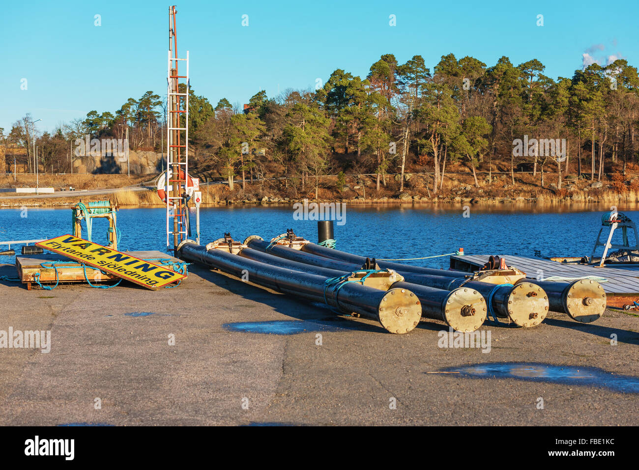 Karlskrona, Sweden - January 13, 2016: Sea cable housing tubes on the dockside in a coastal bay waiting to be deployed at sea. W Stock Photo
