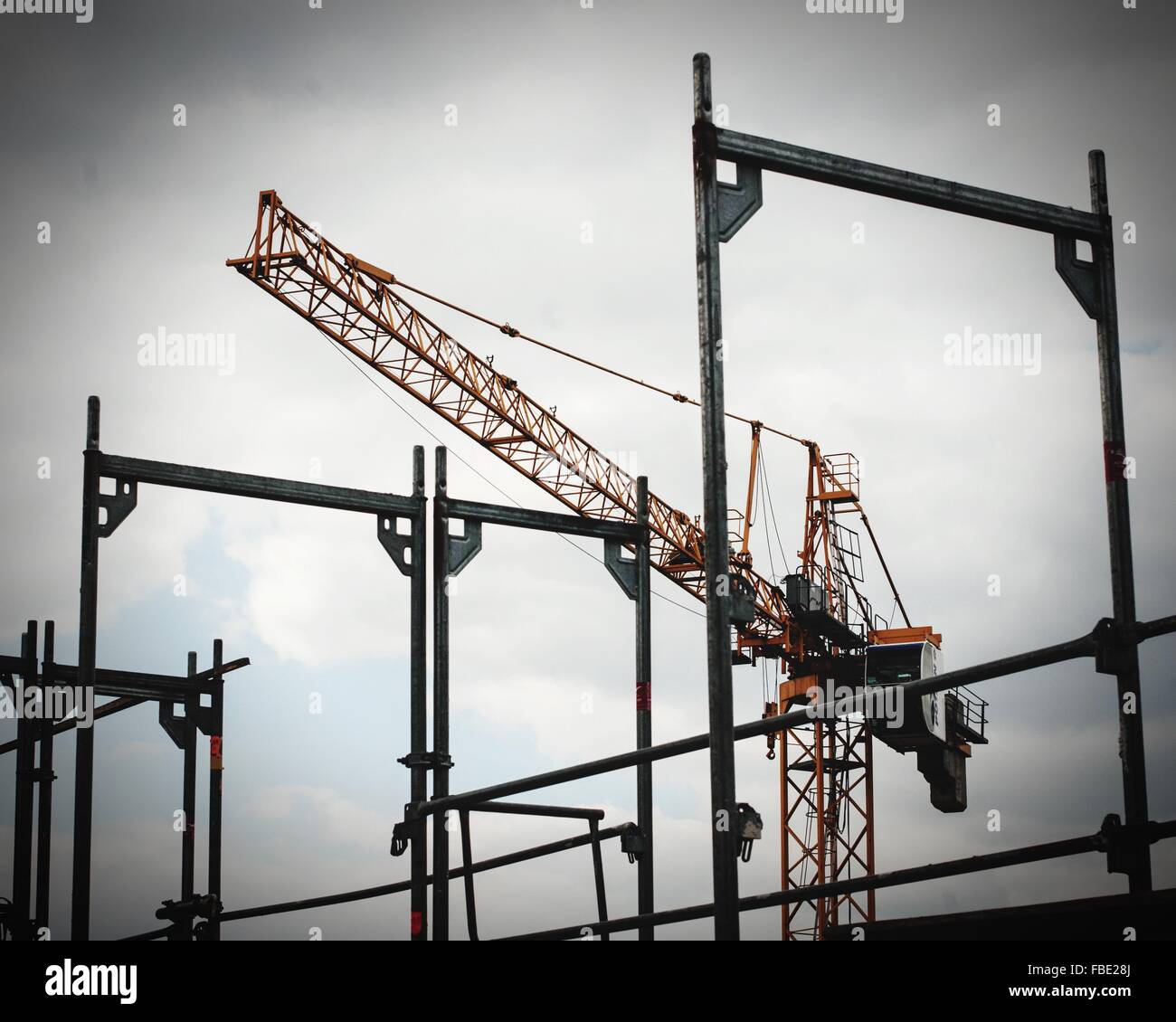 Low Angle View Of Scaffolds And Crane Against Sky Stock Photo