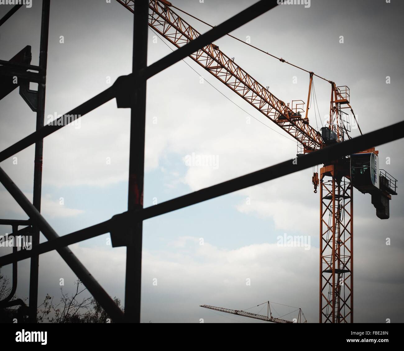 Low Angle View Of Scaffolds And Crane Against Sky Stock Photo
