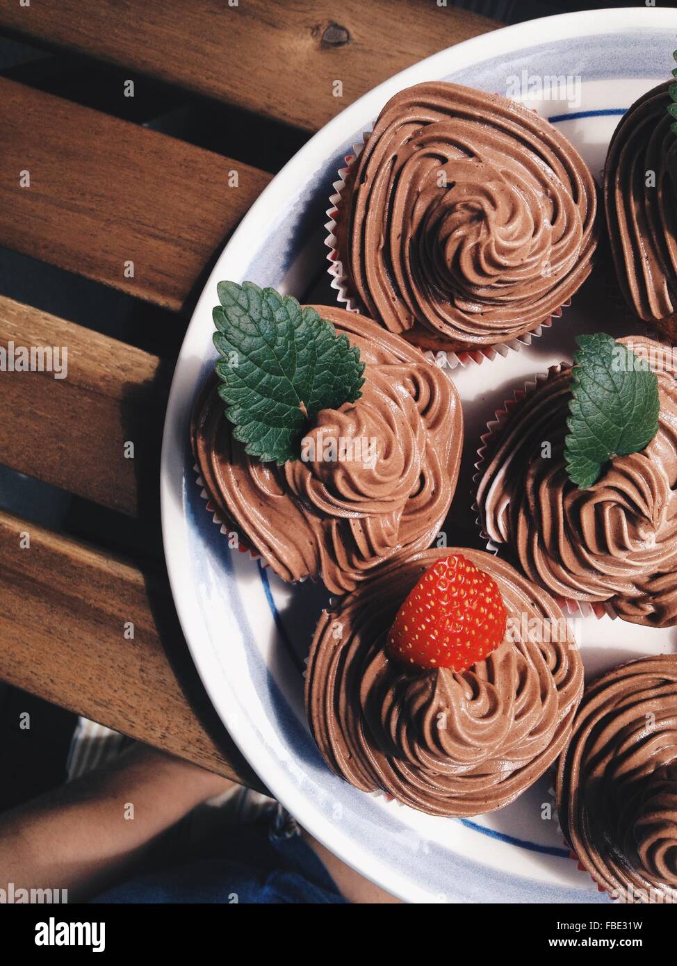 High Angle View Of Chocolate Cupcakes With Swirly Icing In Plate Stock Photo