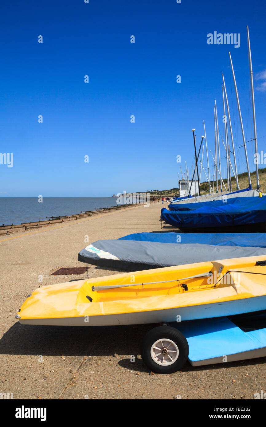 A row of dinghies outside a sailing club at Herne Bay, Kent, England on