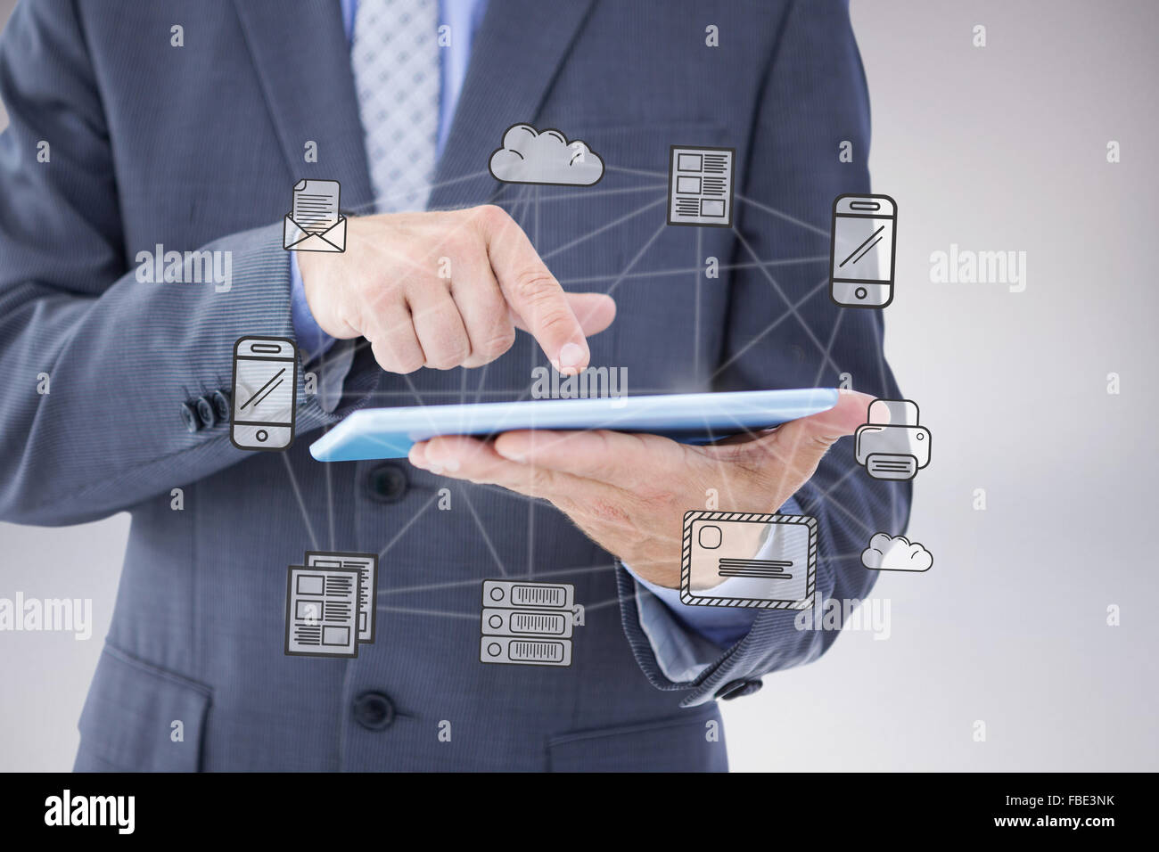 Composite image of businessman using tablet pc Stock Photo