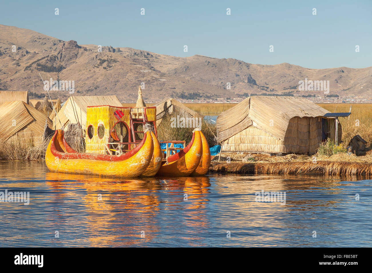 Reed boat on Island of Uros. Those are floating islands on lake Titicaca located between Peru and Bolivia. Colorful image with y Stock Photo