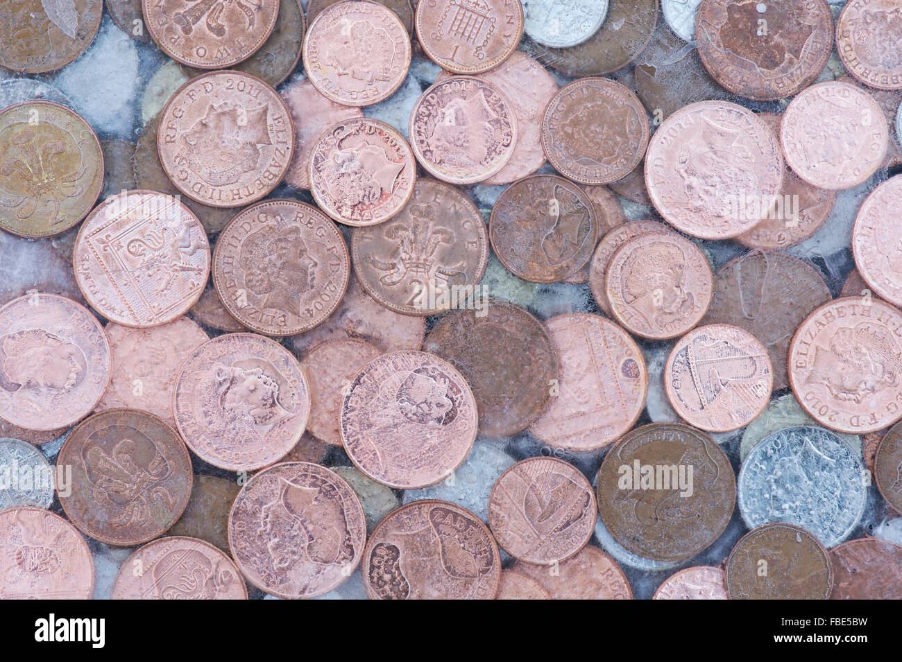 Coins in ice Stock Photo
